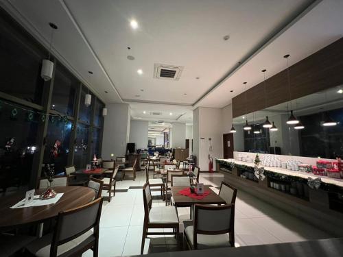 a dining room with tables and chairs in a restaurant at Rio Centro Stay in Rio de Janeiro