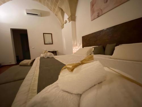 a bedroom with a large bed with a bow on it at Miro B&B in Lecce