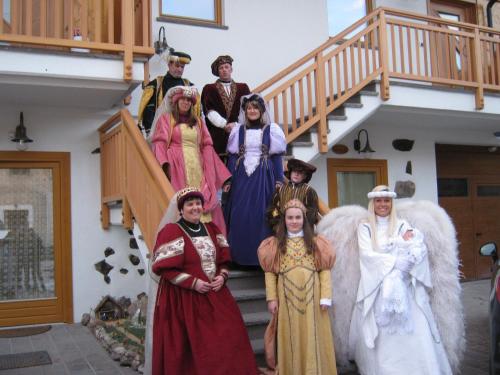 a group of people dressed in costumes standing on stairs at Agriturismo Pisani in Brez