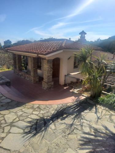 a small house with a tile roof on a patio at Villa Rosa in Latte