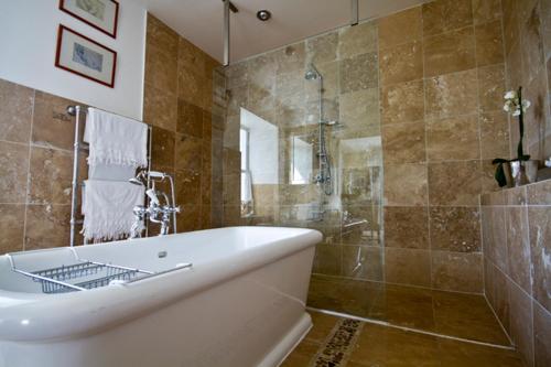 a large bathroom with a tub and a shower at Loch Gorm House in Bruichladdich