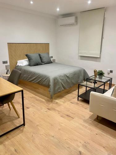 a bedroom with a bed and a living room at villaboutique Jaén in Jaén