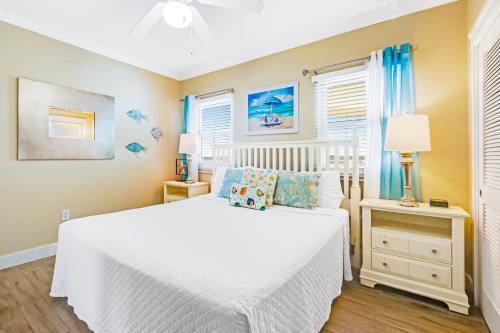 a bedroom with a white bed and a window at Waterscape B624 in Fort Walton Beach