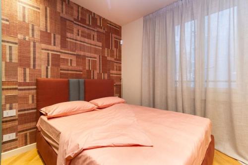 a bedroom with a bed with a large window at La bombonera lagrang3 in Turin