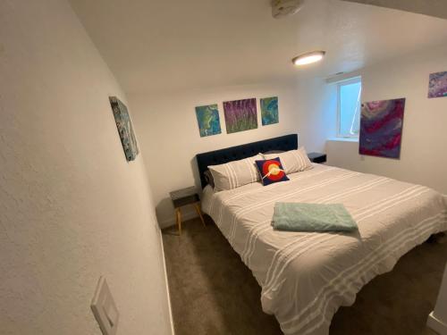 een slaapkamer met een bed met een kussen erop bij Artsy Platt Park Suite, Quick Mountain Access! in Denver