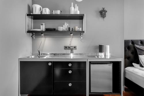 a kitchen with a sink and a shelf at Studio Apartment with Ocean View in Reykjavík