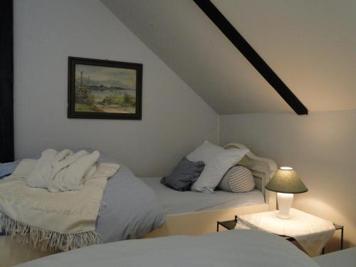 a bedroom with two beds with white pillows at Rosindell cottage in Halle Westfalen