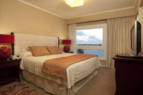 Hotel Patagonia في ريو جاليجوس: غرفة نوم بسرير كبير ونافذة