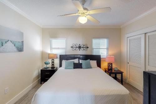 a bedroom with a bed and a ceiling fan at Waterscape B630 in Fort Walton Beach