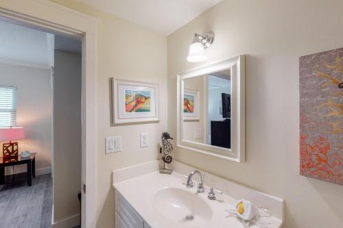 a white bathroom with a sink and a mirror at Waterscape B630 in Fort Walton Beach