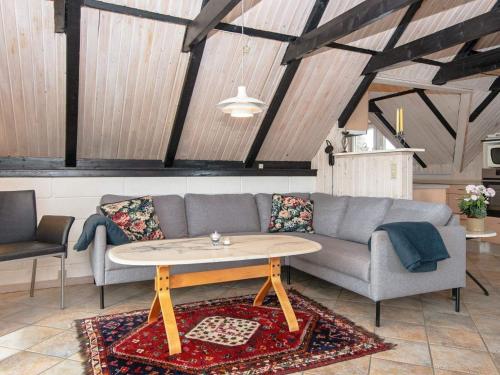 een woonkamer met een bank en een tafel bij 8 person holiday home in Ringk bing in Nørre Lyngvig