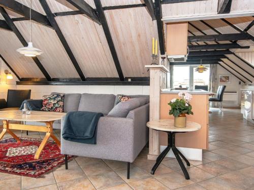 a living room with a couch and a table at 8 person holiday home in Ringk bing in Nørre Lyngvig