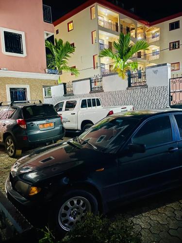 a group of cars parked in a parking lot at Residence SVET in Kribi