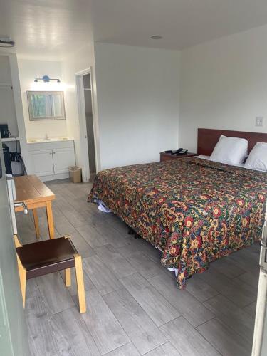 a bedroom with a bed and a wooden table at Americas Best Value Inn Thousand Oaks in Thousand Oaks