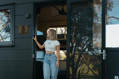 a woman standing in the door of a trailer at CABN Clare Valley in Mintaro