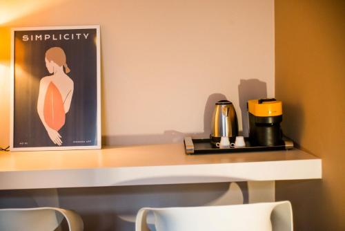a shelf with a coffee maker and a coffee pot on it at Athens Gem in Athens