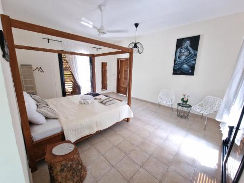 a bedroom with a bed and a table and chairs at Asamai Villas 