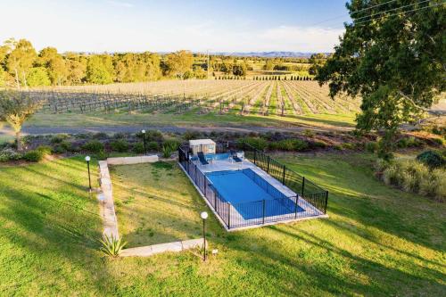an overhead view of a house in a field with a pool at Midnight's Promise - Promise 2 in Lovedale