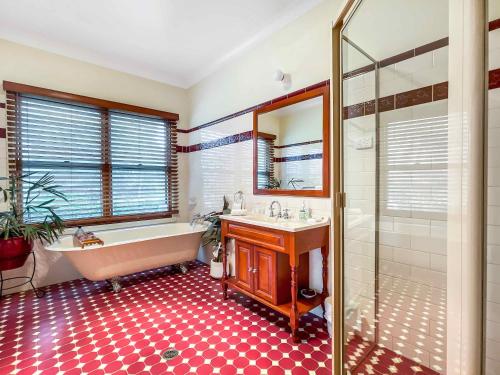 a bathroom with a tub and a sink and a shower at Midnight's Promise - Promise 2 in Lovedale