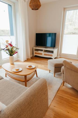 a living room with a couch and a tv at Fine Stuuv in Ratzeburg