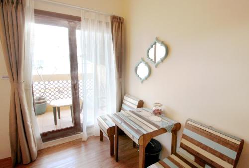 Un comedor con una mesa y una ventana. en 墾丁寵物友善 鐵宿 Tetsu B&B, en Nanwan