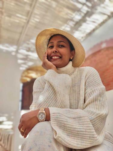 a woman wearing a straw hat and a white sweater at Torya Nubian House in Aswan