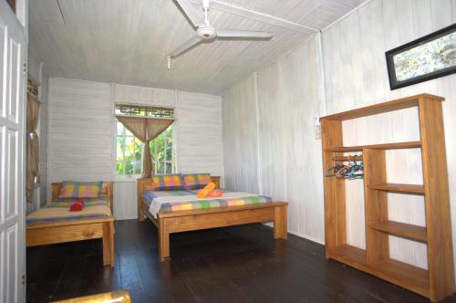 Un pat sau paturi într-o cameră la Happy Gecko Dive Resort