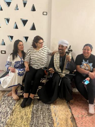 a group of people sitting in a room at Torya Nubian House in Aswan