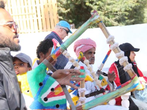a group of people playing with a bamboo pole at Torya Nubian House in Aswan
