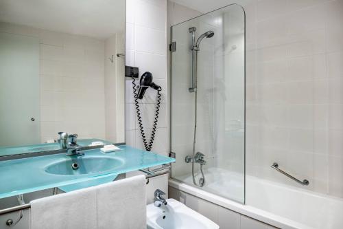 a bathroom with a sink and a shower at AC Hotel La Línea by Marriott in La Línea de la Concepción