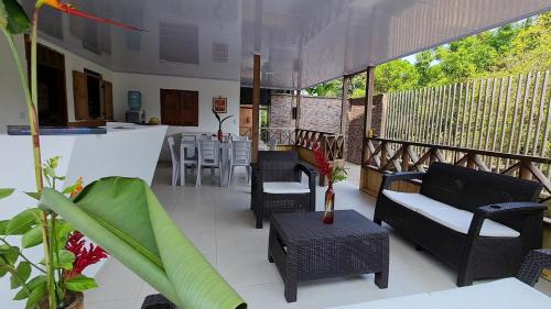 a patio with chairs and a bar on a balcony at Ecohotel Linda Judith in Bahía Solano