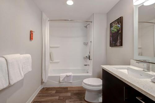 a white bathroom with a toilet and a sink at TownePlace Suites by Marriott San Luis Obispo in San Luis Obispo