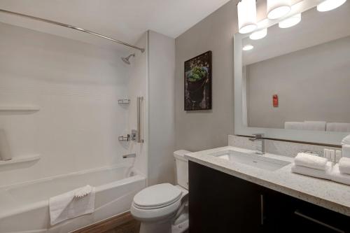 a white bathroom with a toilet and a sink at TownePlace Suites by Marriott San Luis Obispo in San Luis Obispo