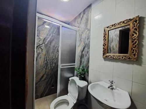 uma casa de banho com um chuveiro, um WC e um lavatório. em Casa de verano con Piscina San Andres em San Andrés