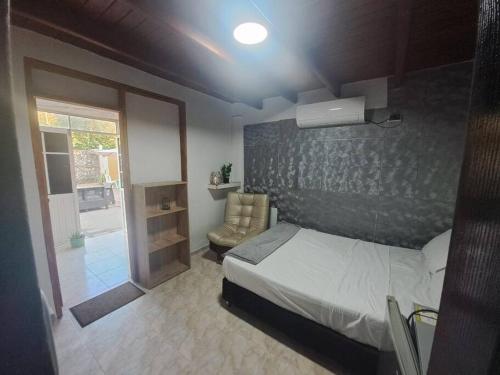 a bedroom with a bed and a window and a door at Casa de verano con Piscina San Andres in San Andrés
