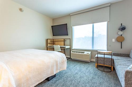 a bedroom with a large bed and a window at TownePlace Suites by Marriott Raleigh - University Area in Raleigh