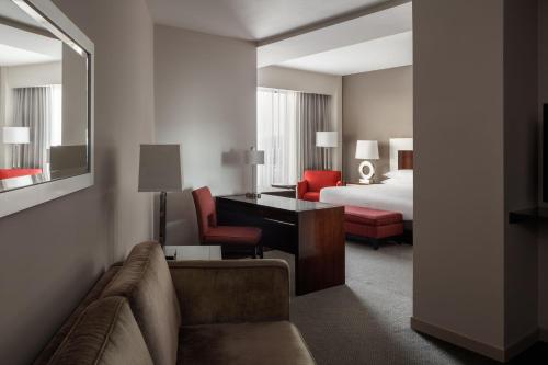 a hotel room with a bed and a couch and a desk at Marriott Panama Hotel - Albrook in Panama City