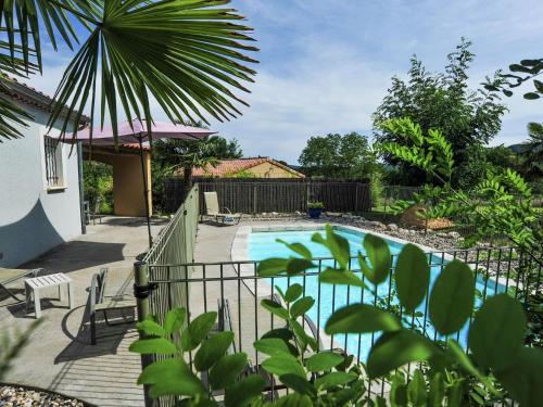 a swimming pool in a yard with a fence at Charming villa with private pool near the Ard che river in Auriolles