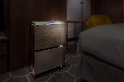 a small refrigerator sitting on a floor next to a bed at Hotel GrandBach Tokyo Ginza in Tokyo