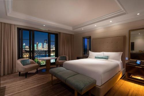 a bedroom with a bed and a view of a city at The St. Regis Atlanta in Atlanta