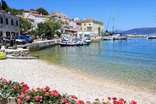 a group of boats are docked in a harbor at Apartments by the sea Valun, Cres - 20860 in Valun