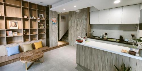 a kitchen with a counter and a chair in a room at 定春行旅 Haru Guesthouse in Tainan