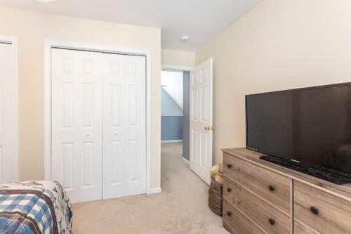 a bedroom with a flat screen tv on a dresser at *4BR 2BA N Shore Hidden Retreat* in Roscommon