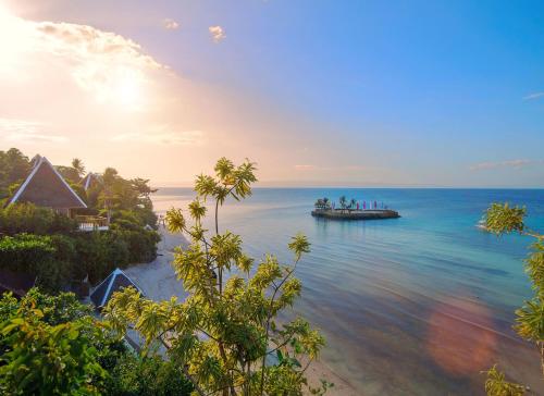 a boat in the ocean with a group of people on it at Mithi Resort & Spa in Panglao