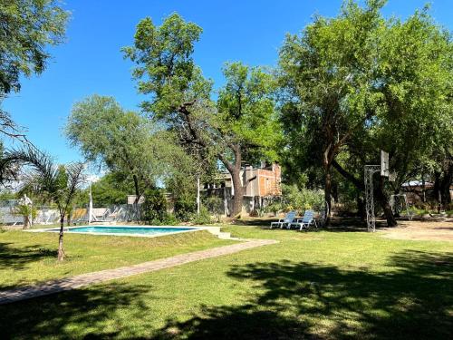 een tuin met een zwembad en bomen en een huis bij Finca Lo de Jose in La Banda