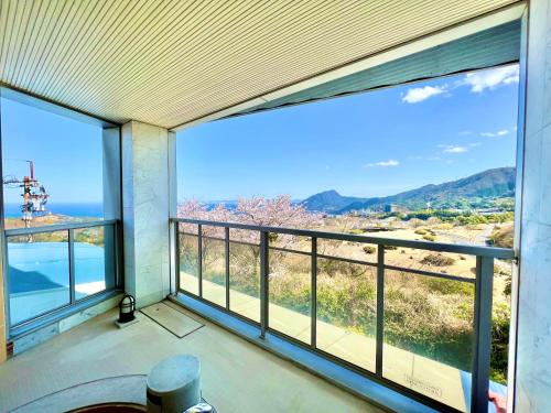 a view from the balcony of a house with large windows at HOTEL In the Woods ,Love Hotel in Beppu