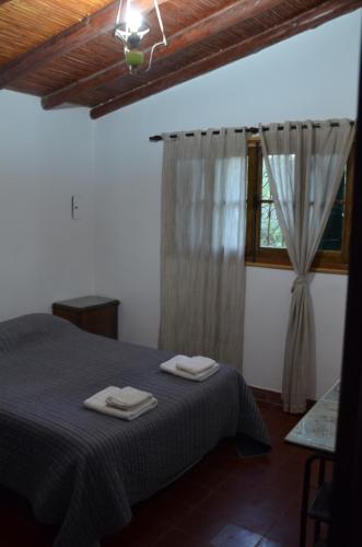 a bedroom with a bed with two towels on it at Rios libres in Potrerillos