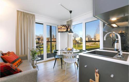 a kitchen and living room with a sink and a table at Pet Friendly Apartment in Lembruch