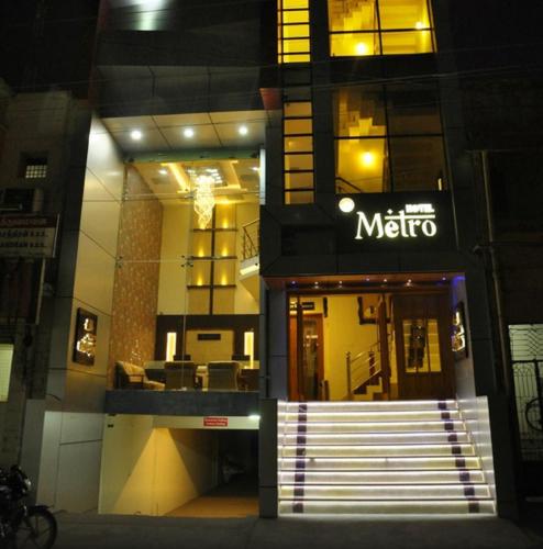 a store with a metro sign on the side of a building at Hotel Metro in Kumbakonam