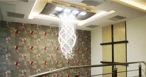 a chandelier hanging from the ceiling in a room at Hotel Metro in Kumbakonam